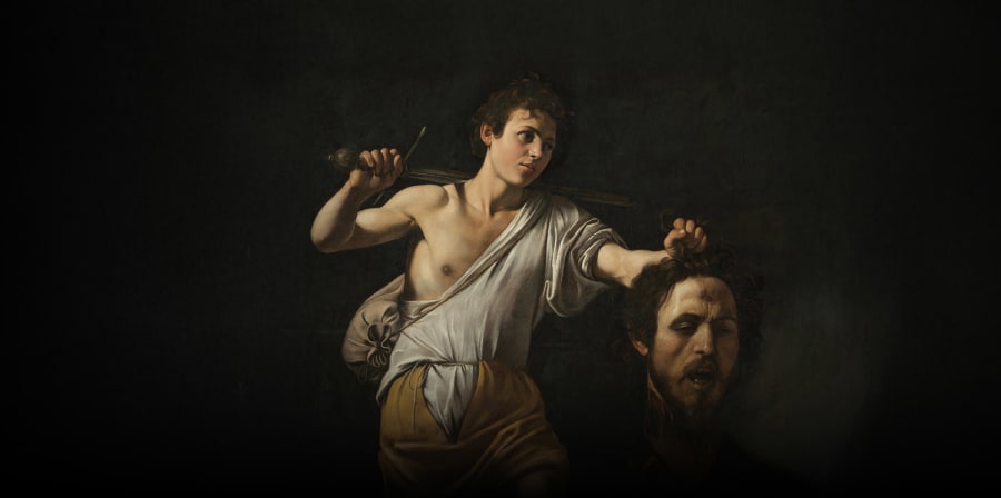 Renaissance style painting of a boy holding a man's head and dagger