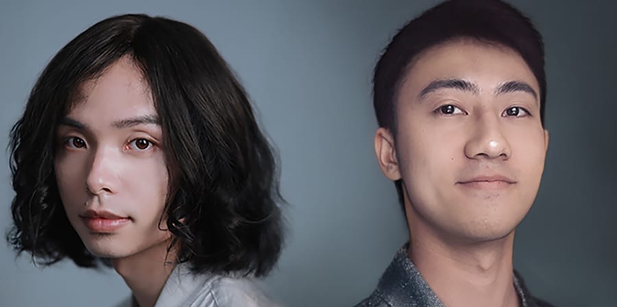 Two people standing back to back in studio lighting, wearing textured grey and silver clothing.