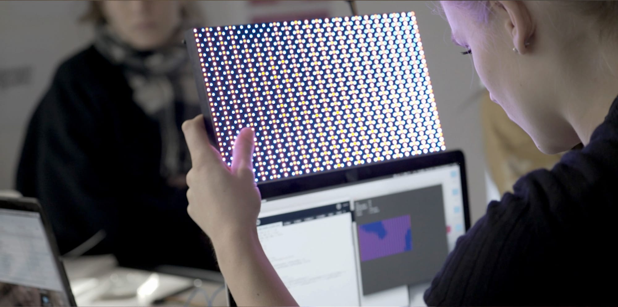 Student holding up a digital tool