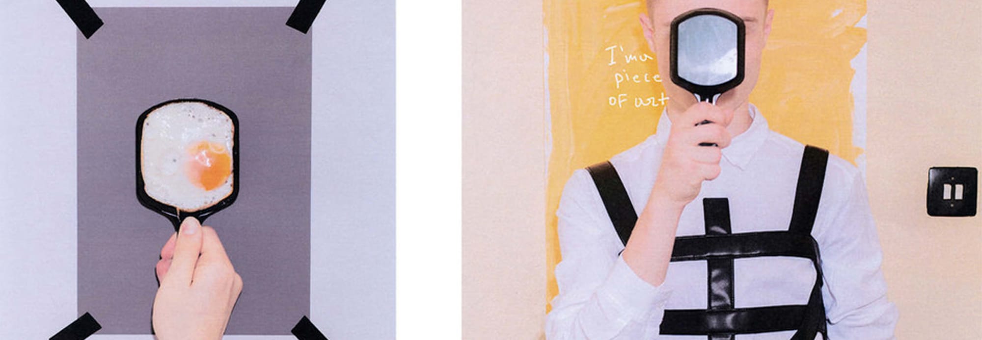 Close up shot of a fried egg in a spatula and a young man covering his face with another spatula.