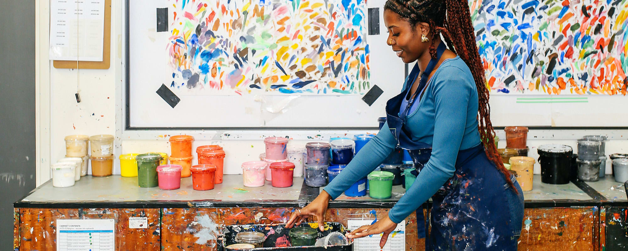 student choosing ink in printing workshop
