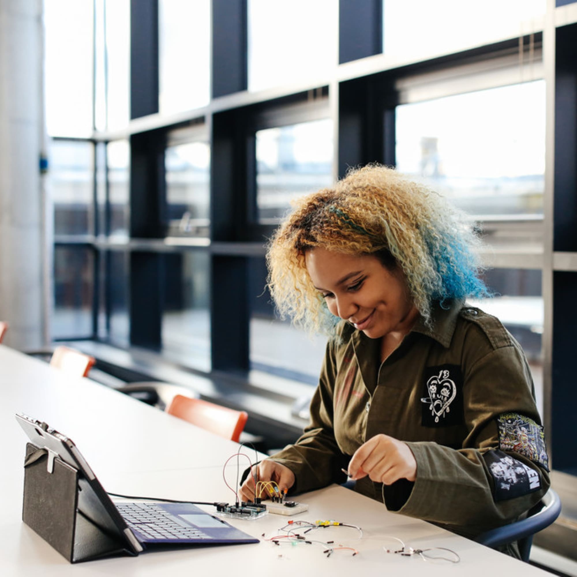 Val Toro smiling while working with computational components