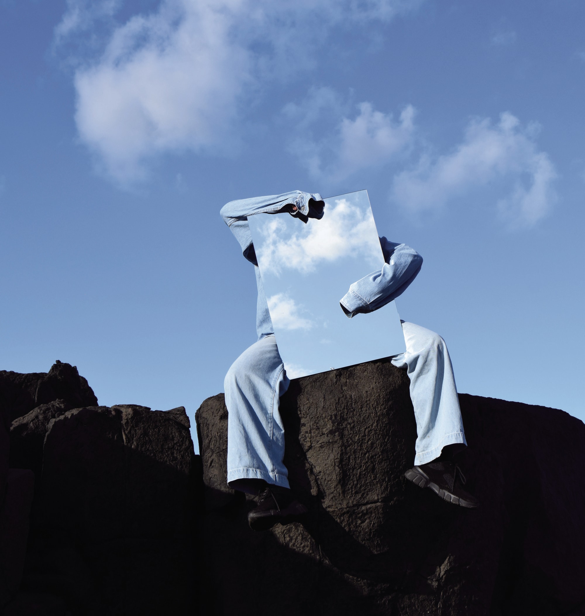 Person holding mirror to the sky