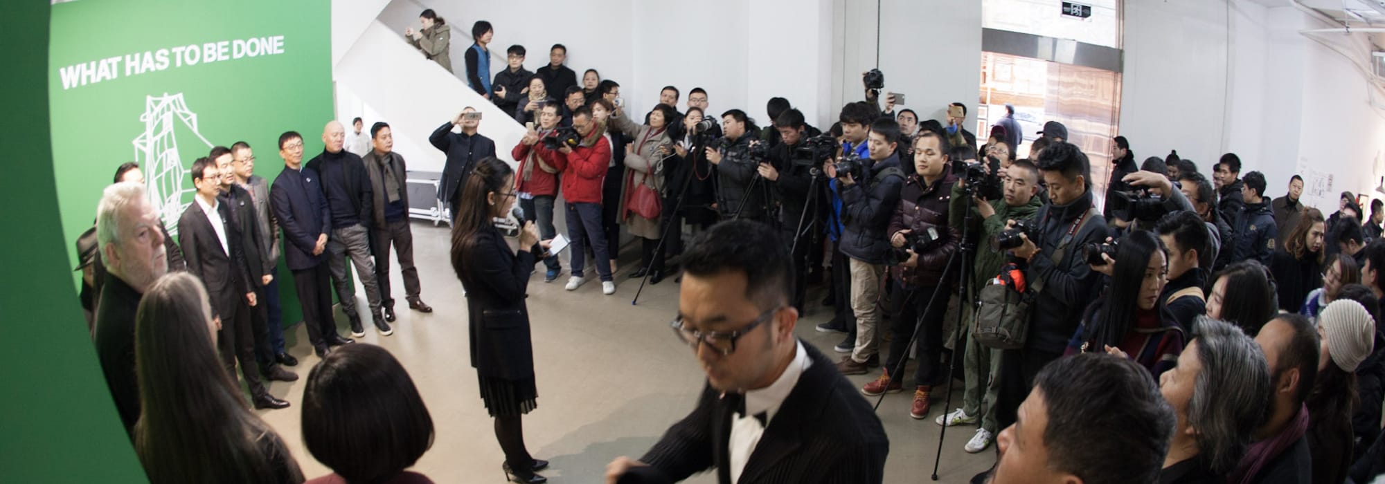 People stood listening to someone present