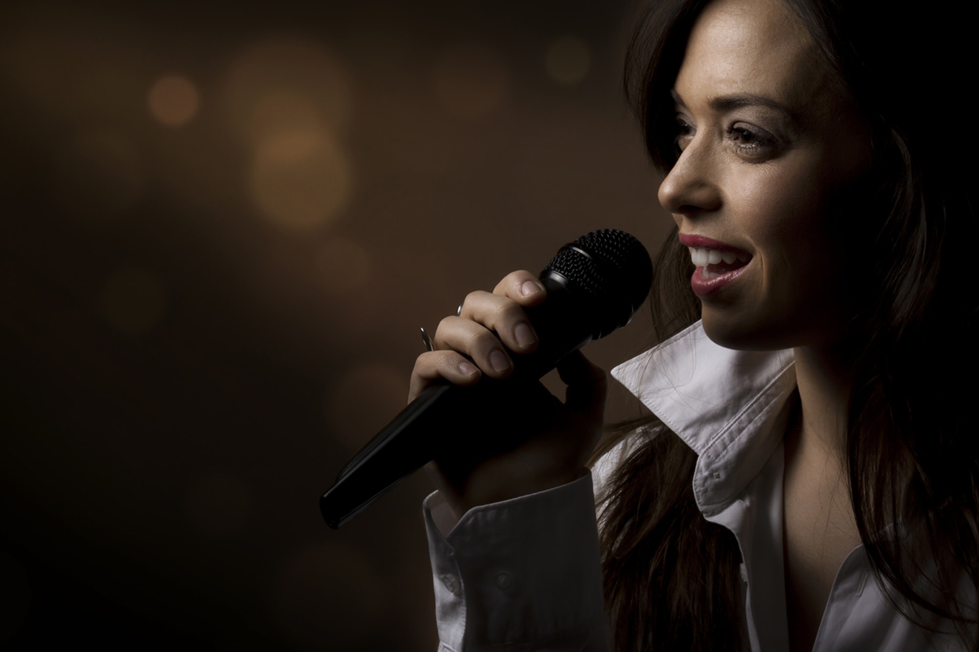 Woman singing into microphone