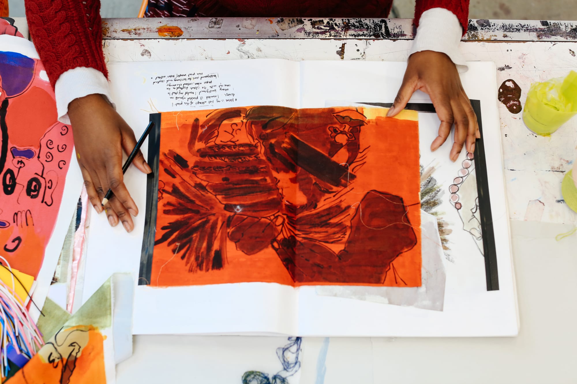 Picture of a student's hands showing their sketchbook