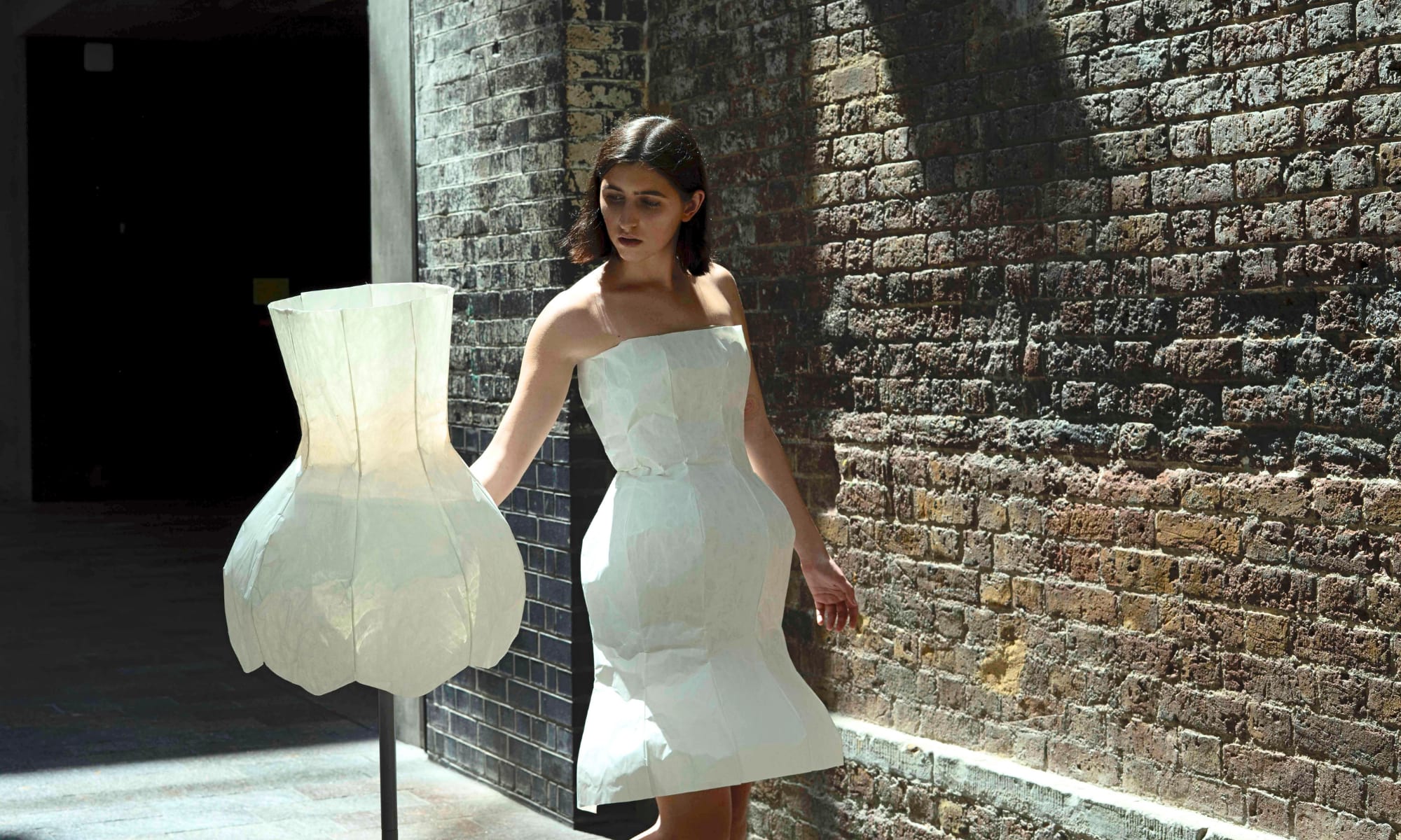 A person dressed in a lamp shade at Central Saint Martins fashion university