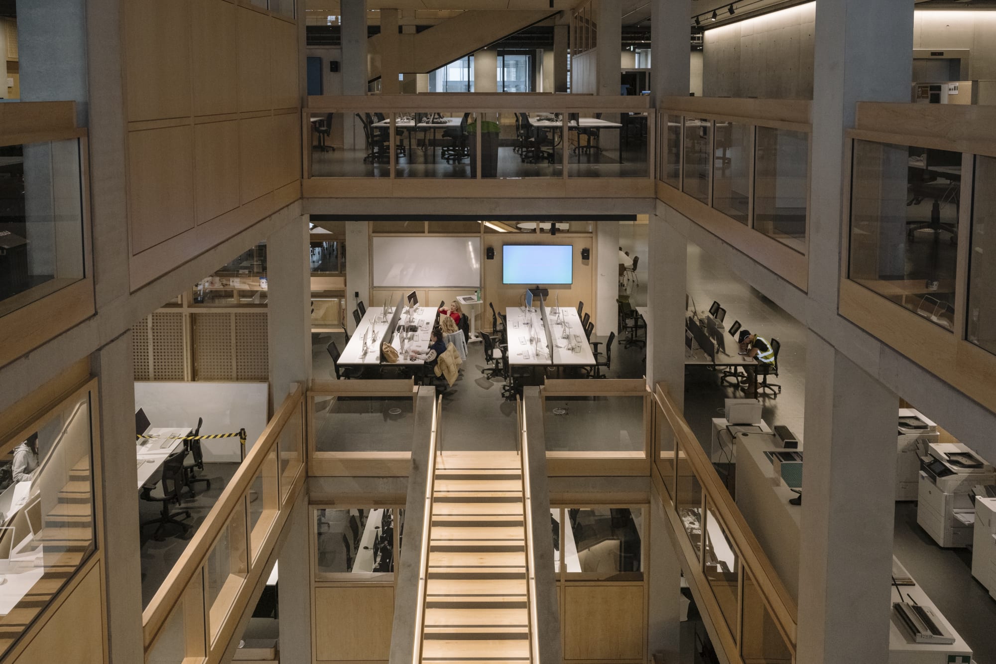 Birds eye shot of building with people sat at computers 