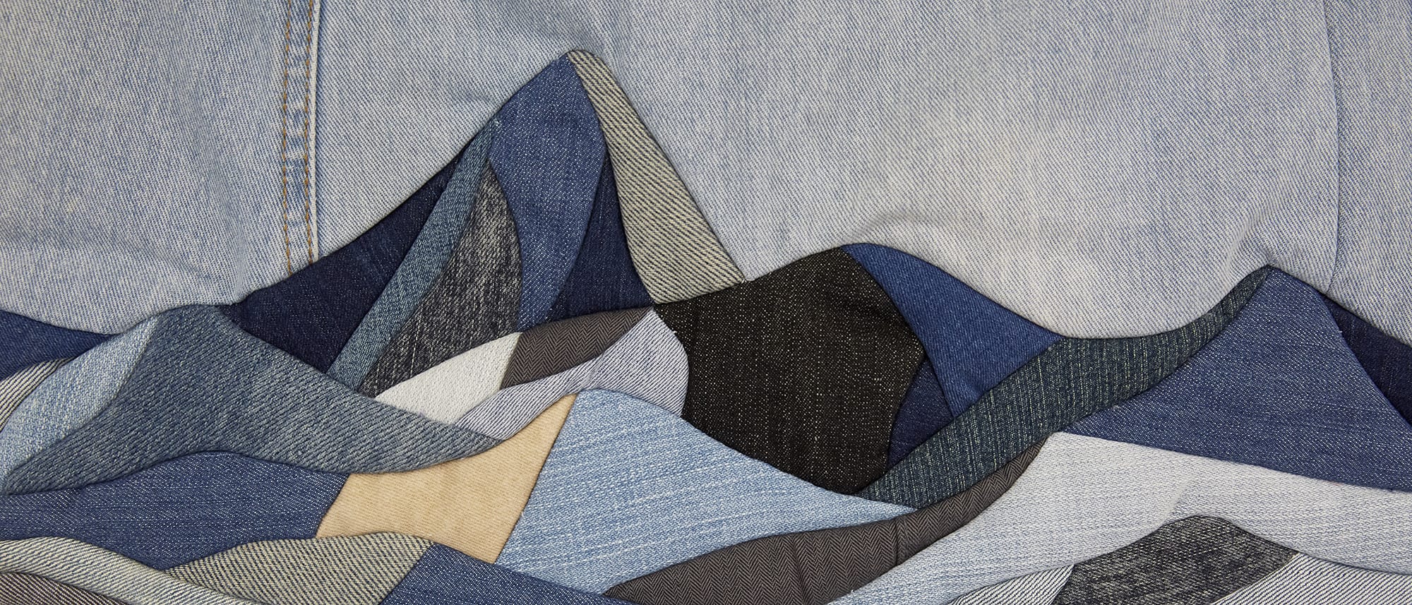 Mountain landscape scene made out of denim patchwork collage