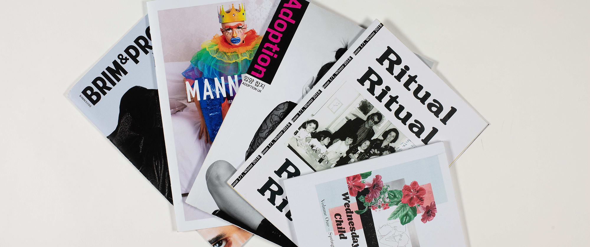 A fan of magazines covers shot against a white background.