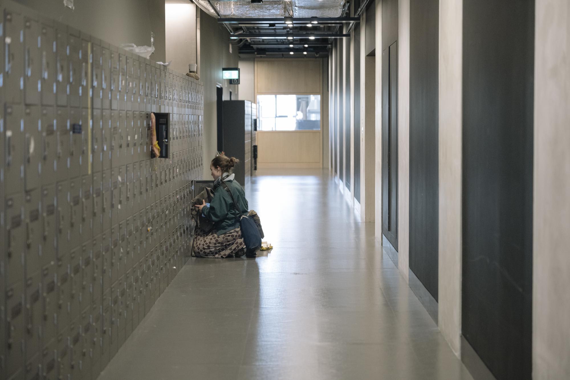 Student in corridor using a locker at East Bank.