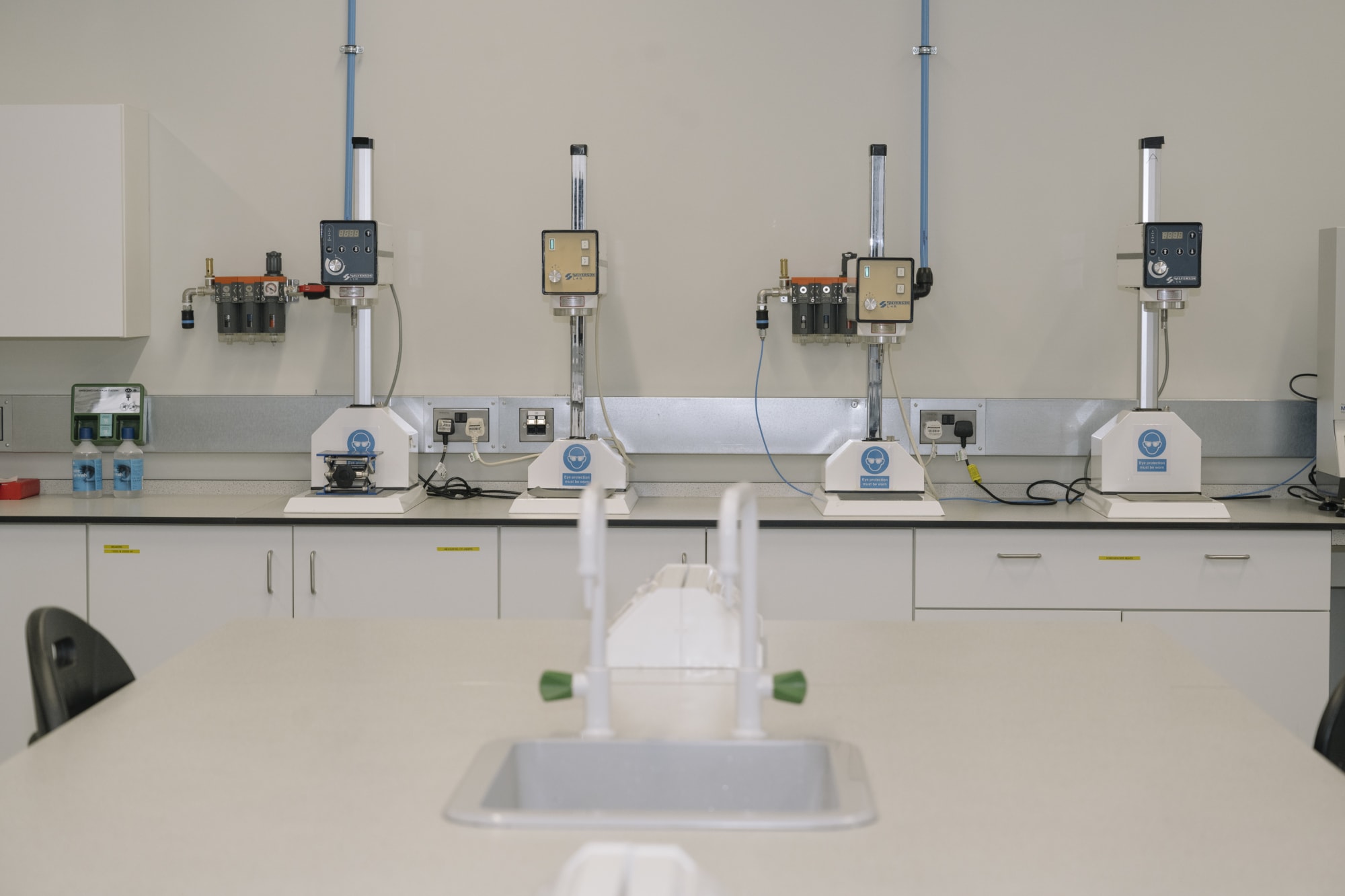 Laboratory with four machines on a table.