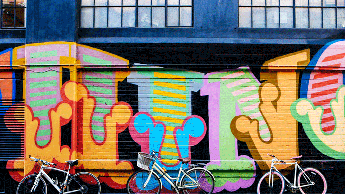 Bikes against a graffiti wall near London College of Fashion