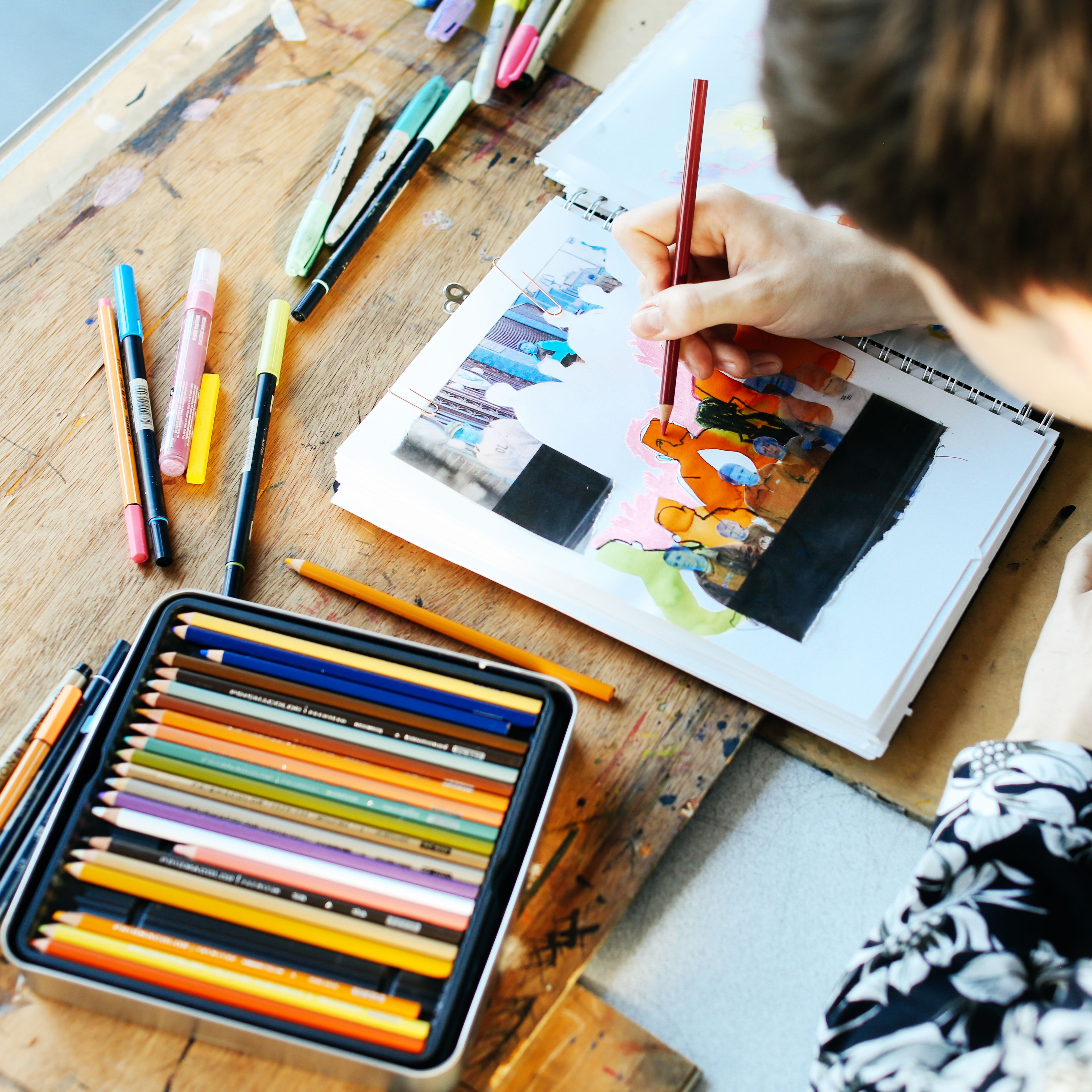 Student drawing with pencils
