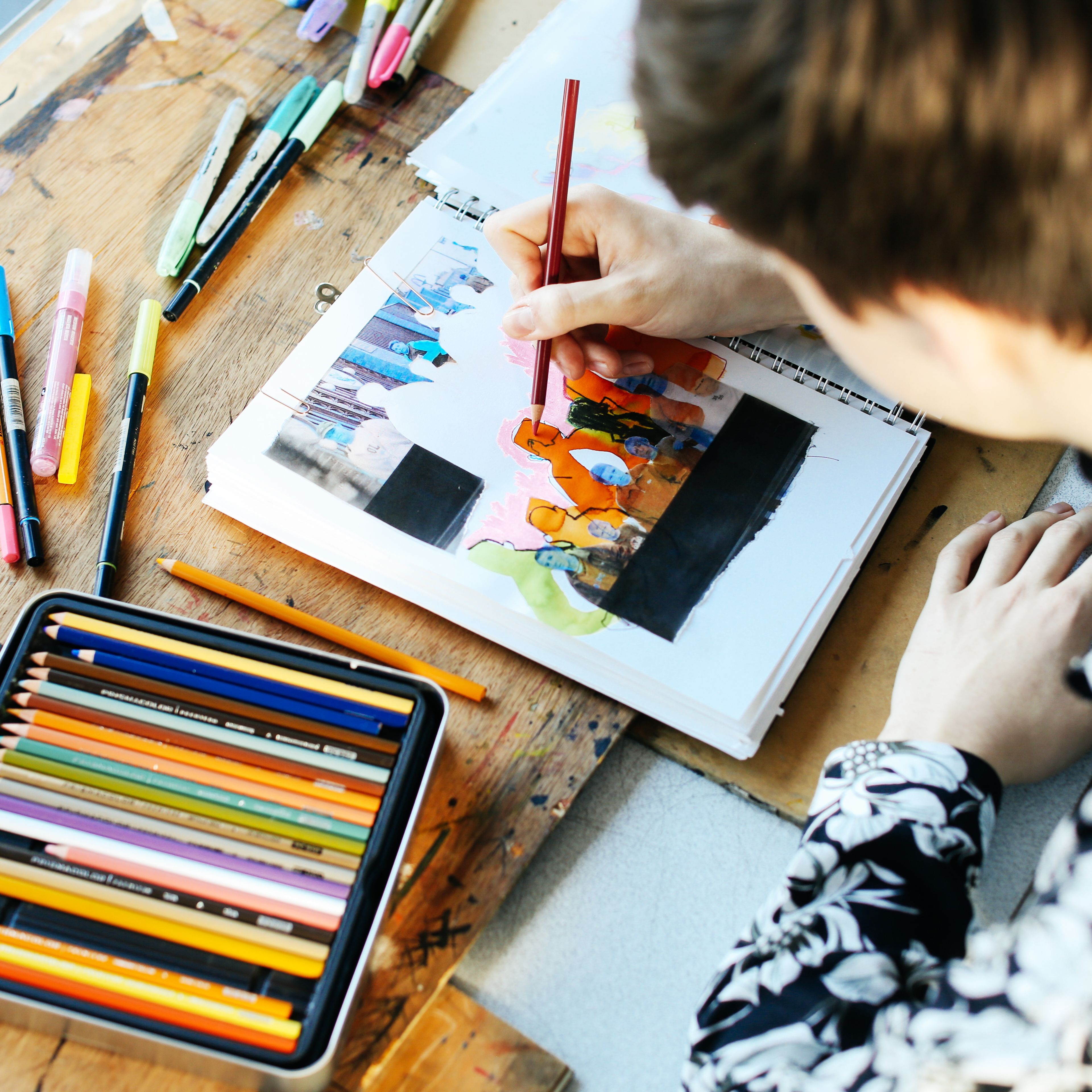 Student drawing with pencils