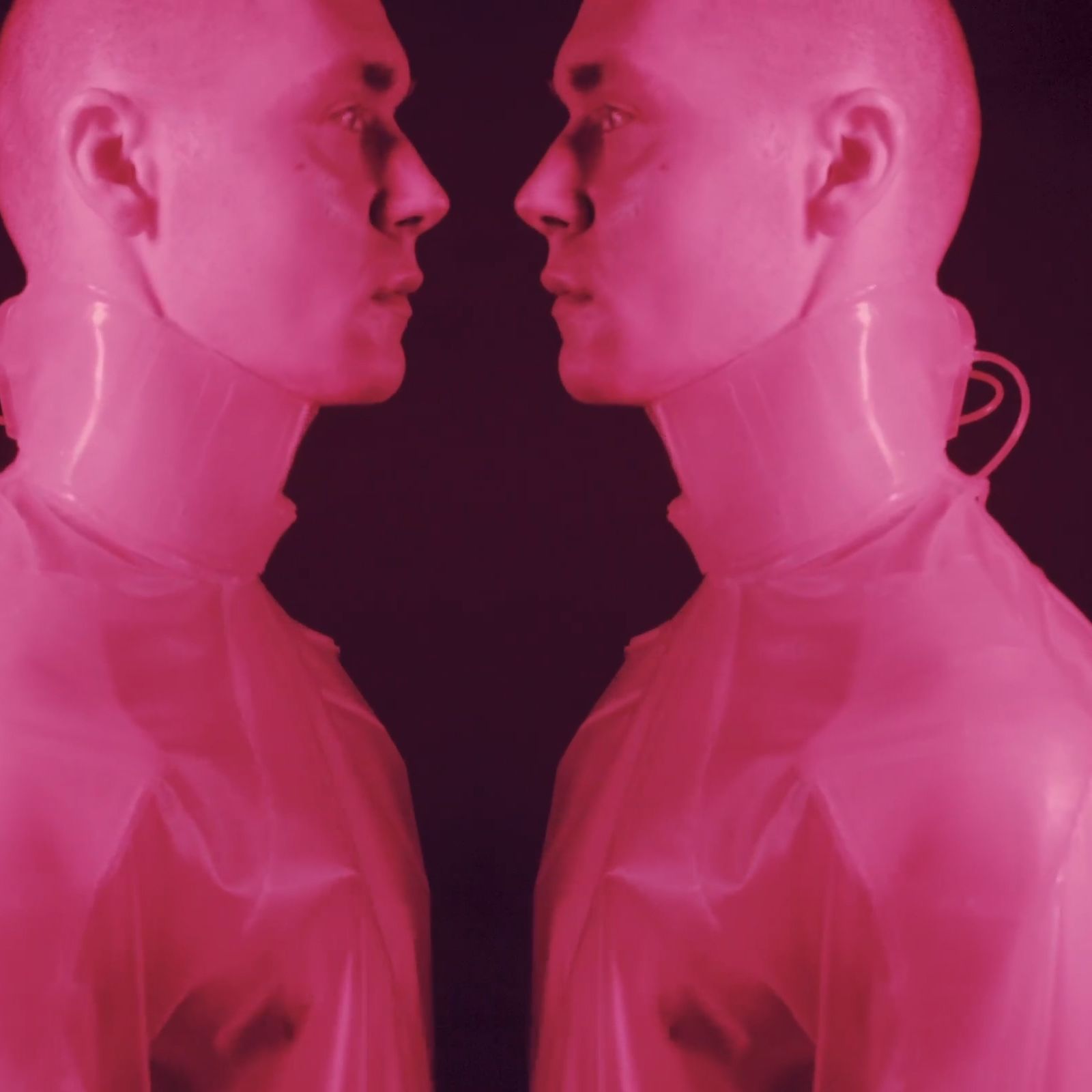 Two male models in pink atmospheric light.