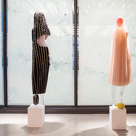 Two mannequins dressed in abstract garments on display in the Lethaby Gallery