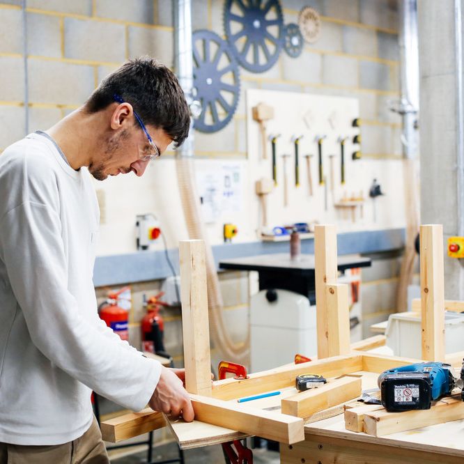 Boy assembling a wooden model 