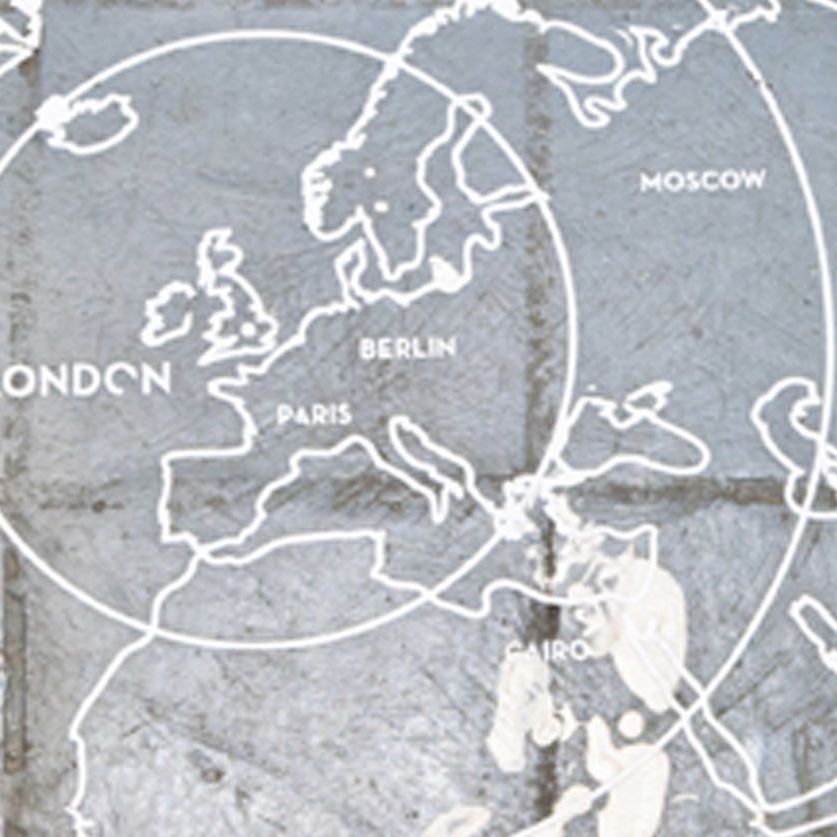 A map of Europe and other continents drawn on a cobbled floor