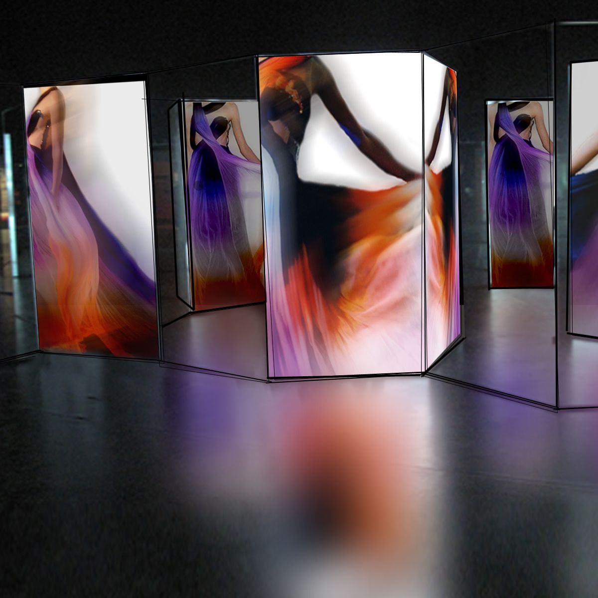 A dark room with lit up panels showing dresses, blurred to give the feeling of movement. MA Fashion Curation, Multimedia Installation by Daniel Caulfield-Sriklad