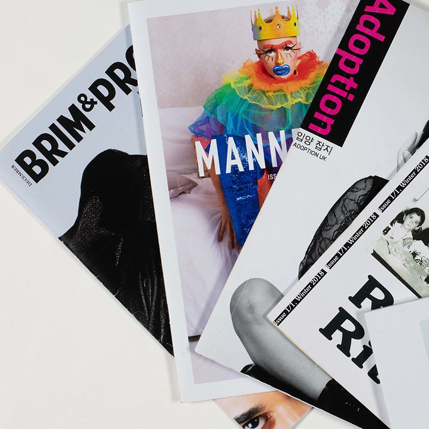 A fan of magazines covers shot against a white background.