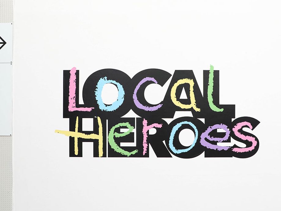 Image depicts a wall exhibit which reads 'Local Heroes' in a large, colourful font.
