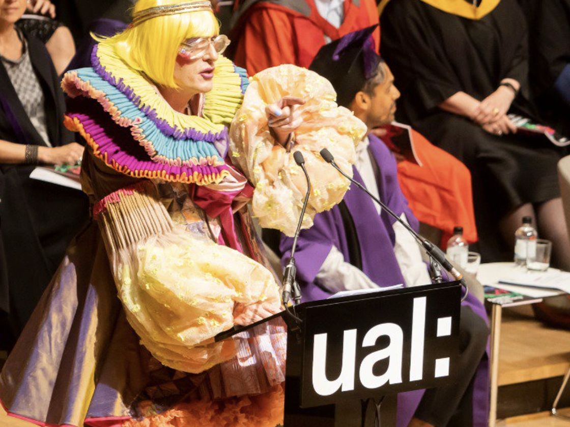 Grayson Perry wearing robes designed by Rachele Terrinoni standing on the stage at graduation