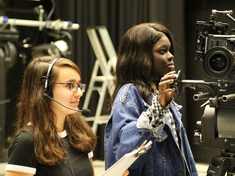 Three women project manage a film-shoot.