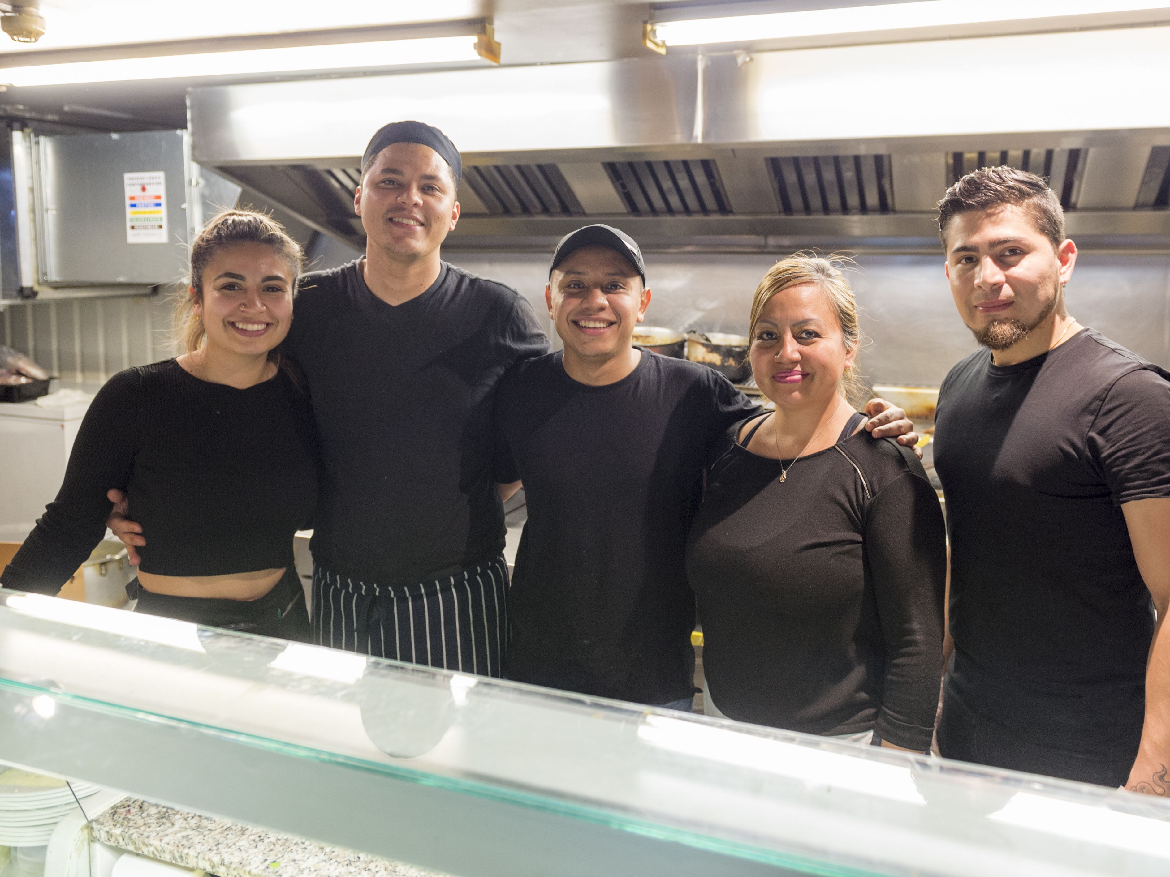 Staff at Costa Azul behind the counter at their restaurant.