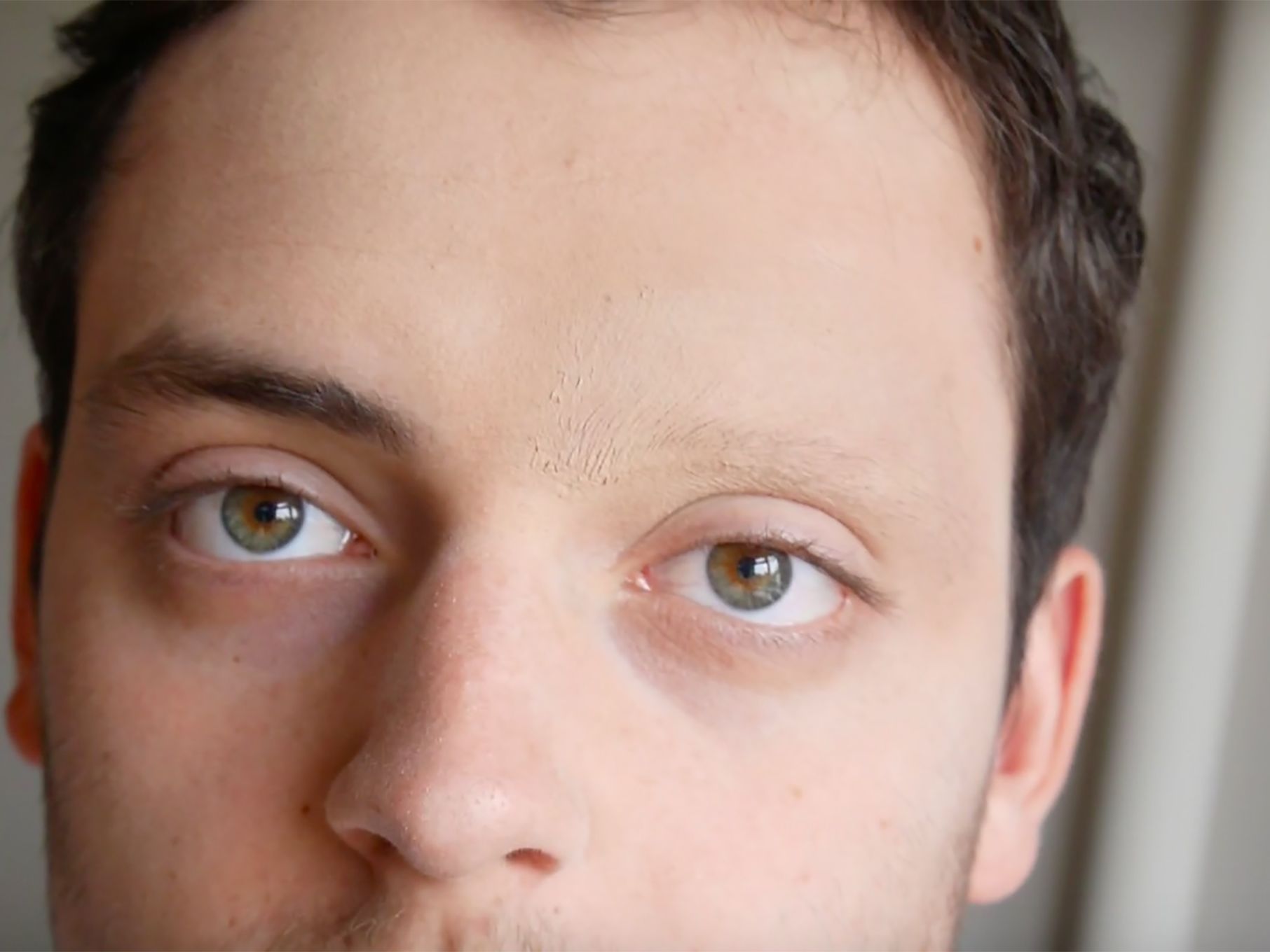 a close-up portrait of a person with one eyebrow missing