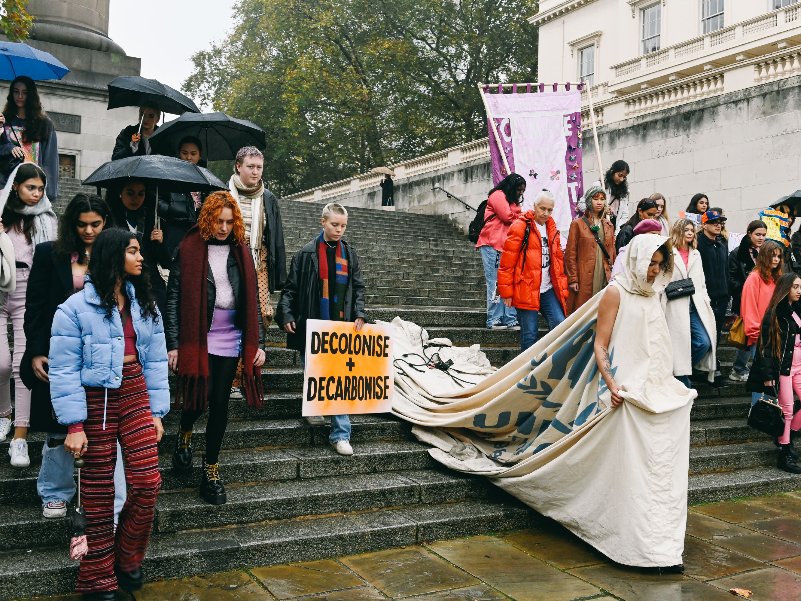Model wearing large dress made from refugee tent
