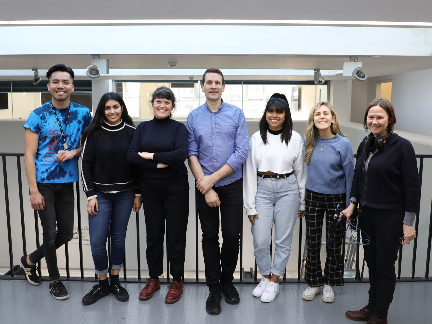 Posed group photo of Bruce Daisley with BBC producer and LCC students smiling at camera