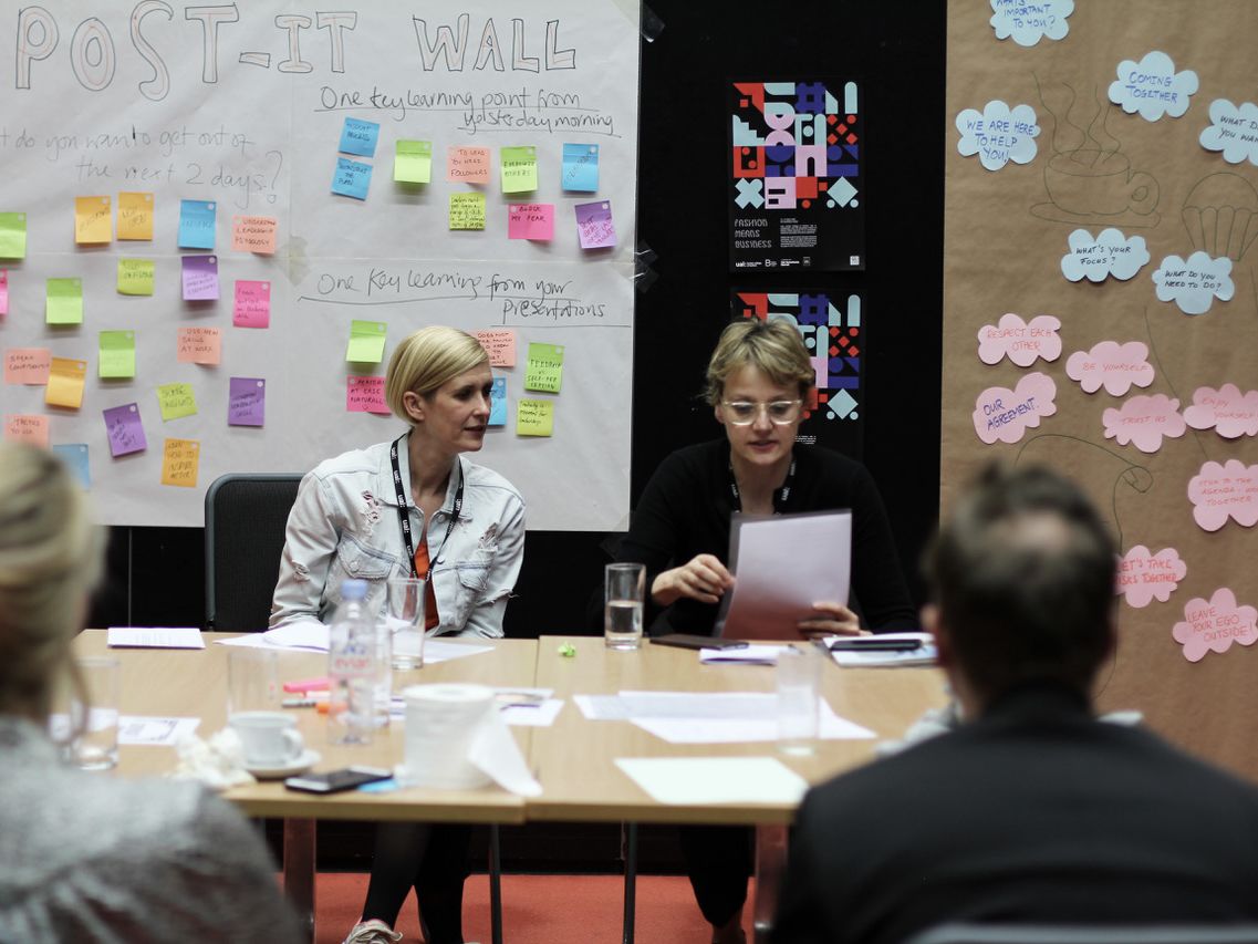 Tutors running a workshop from a table
