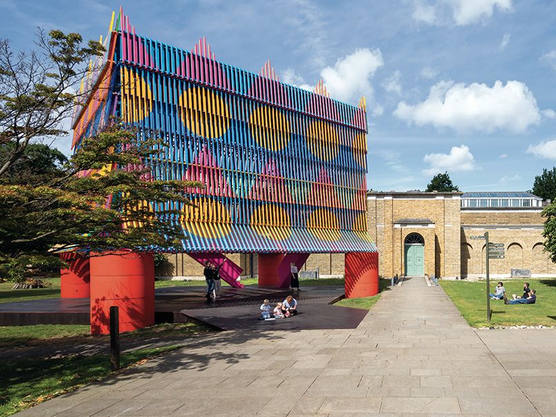 Image depicts a brightly coloured structure, the Colour Palace, erected in front of Dulwich Picture Gallery.
