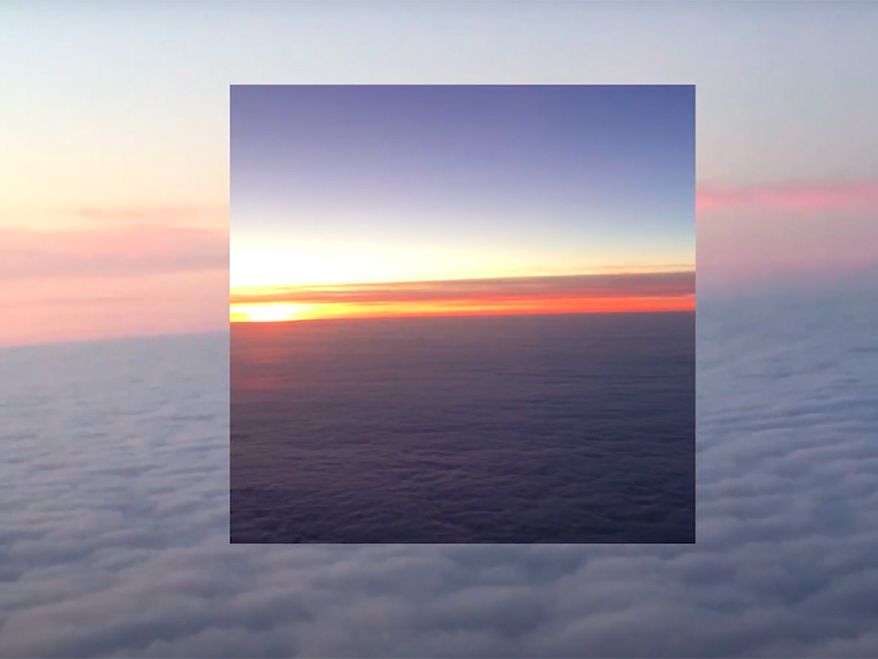 A still from a music video featuring a collage-effect sky.