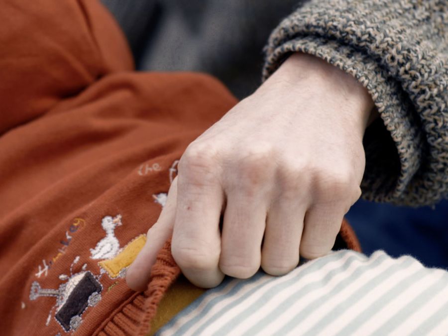 Still of a zoom shot of people holding hands.