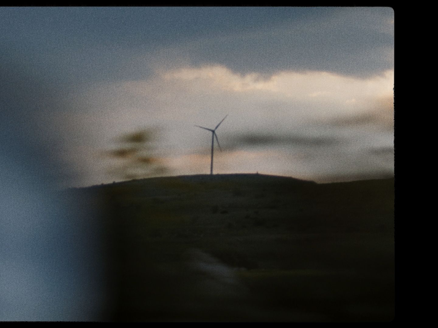 A landscape featuring a windmill.
