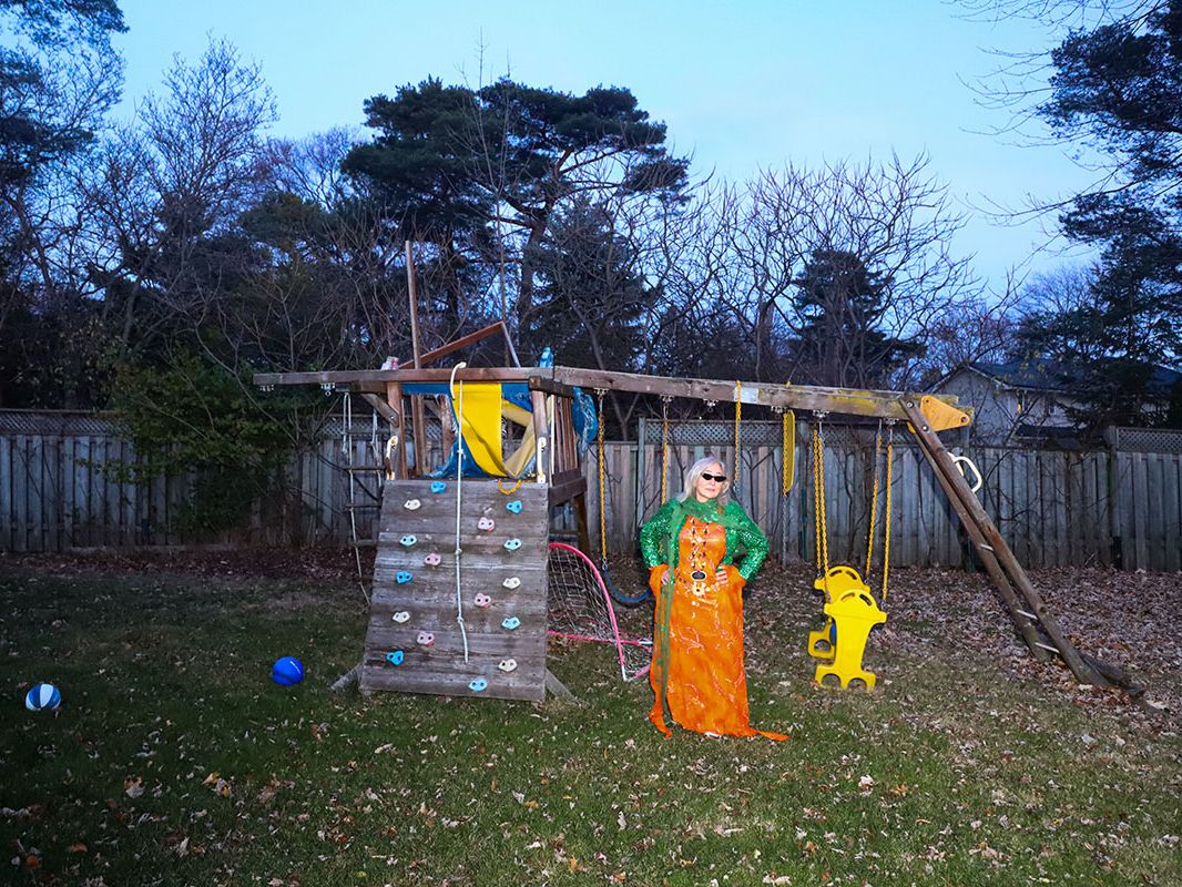 Photograph of a woman standing in a garden.