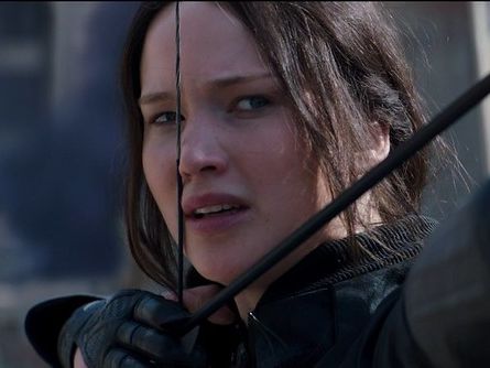 Actor Jennifer Lawrence holding a bow and arrow as Katniss Everdeen in film The Hunger Games: Mockingjay - Part 2 (2015).