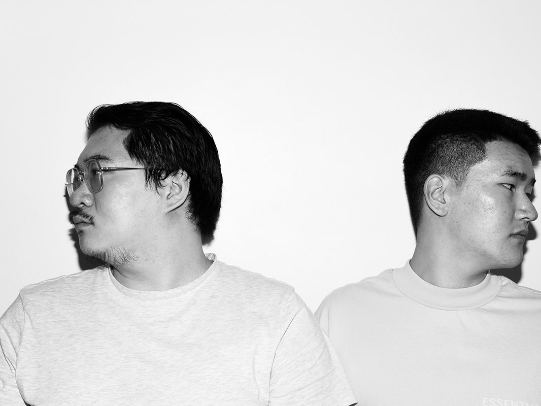 Photograph of two people facing away from each other.