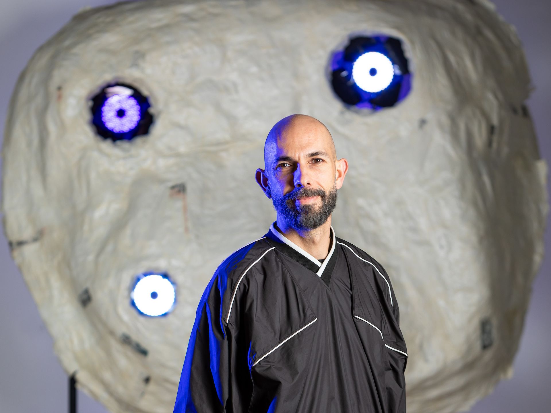 Xavi standing in front of a decorative installtion