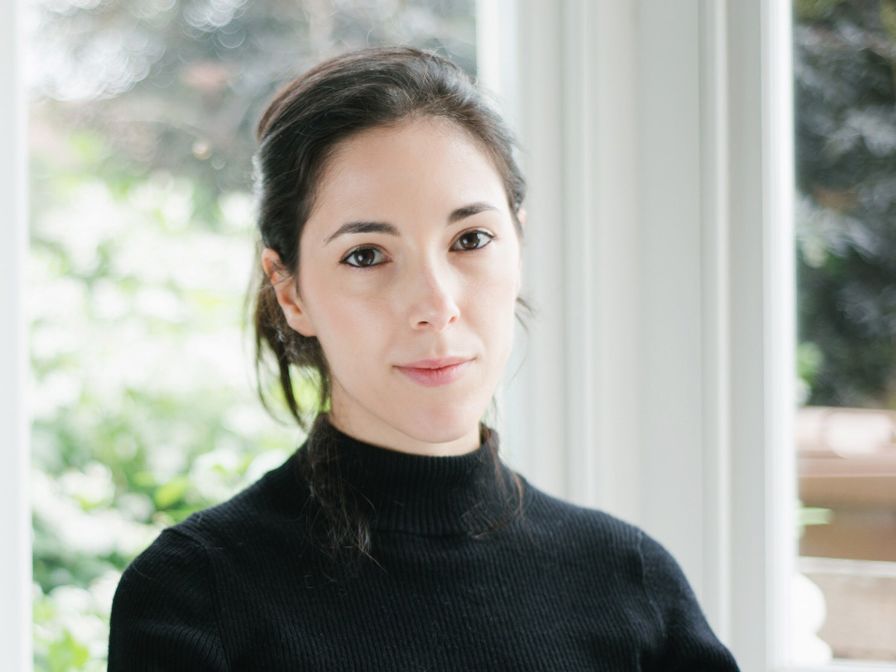 Portrait of Chiara, who has fair skin and black hair, wearing a black turtleneck