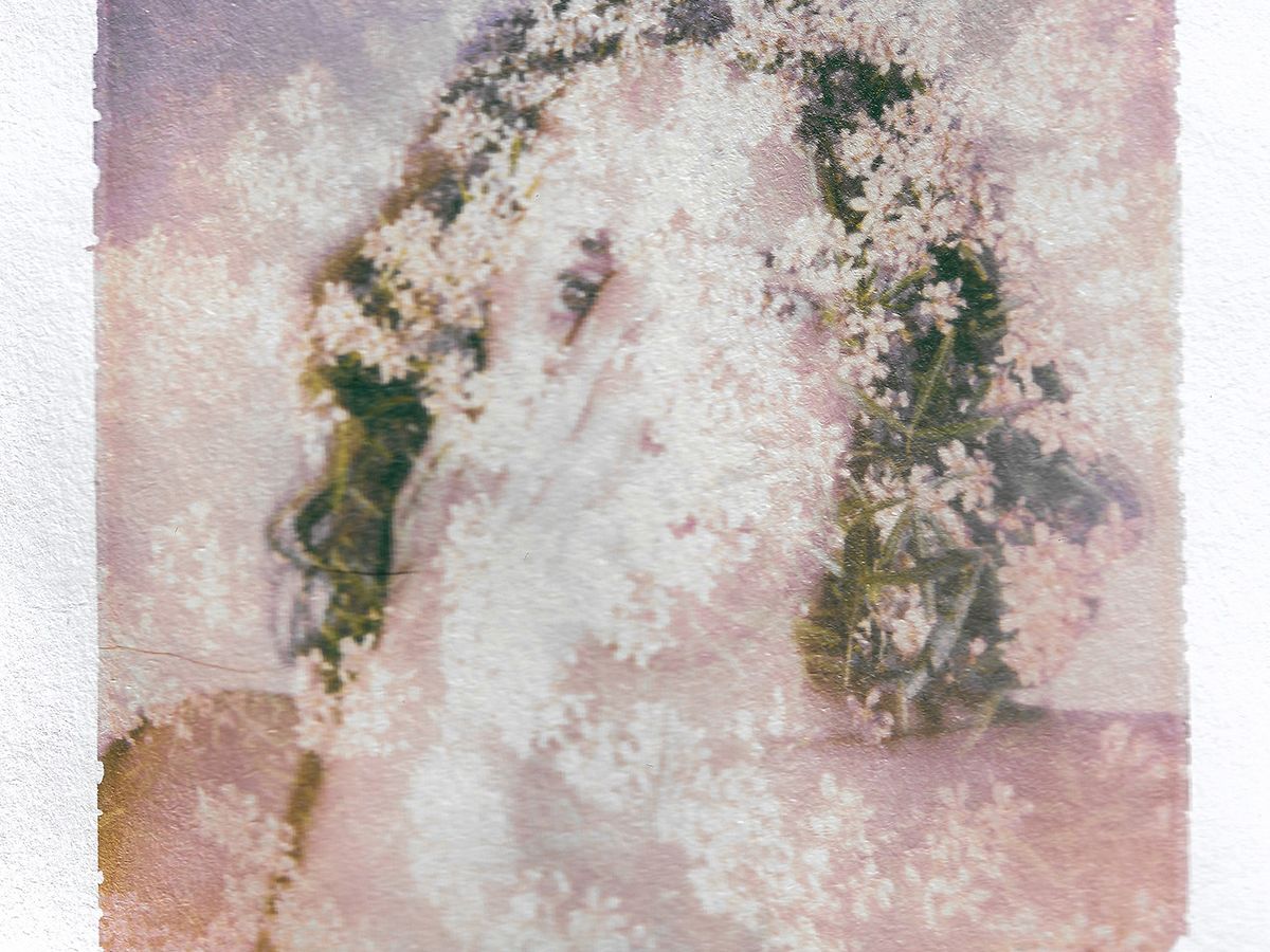 A blurred photograph of a woman.