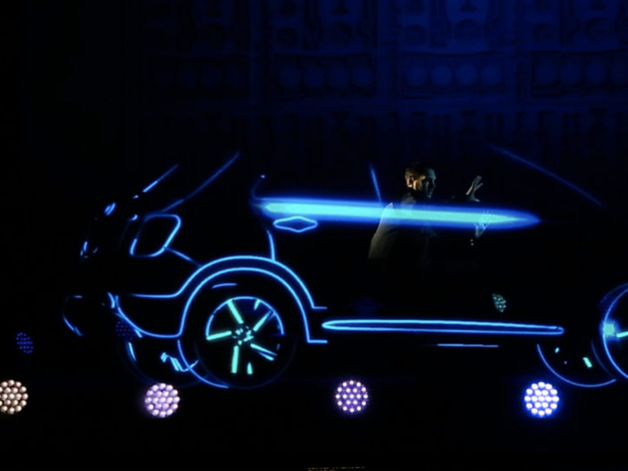 Person on stage driving car
