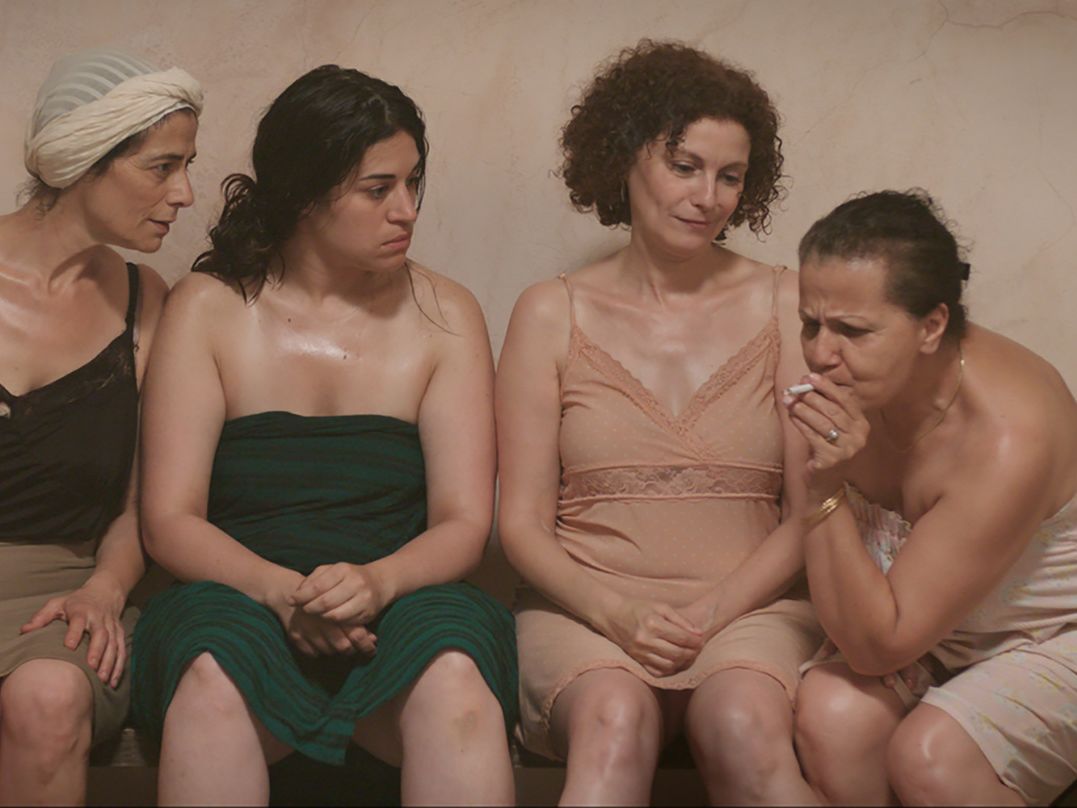 A film still of women in a public bath.
