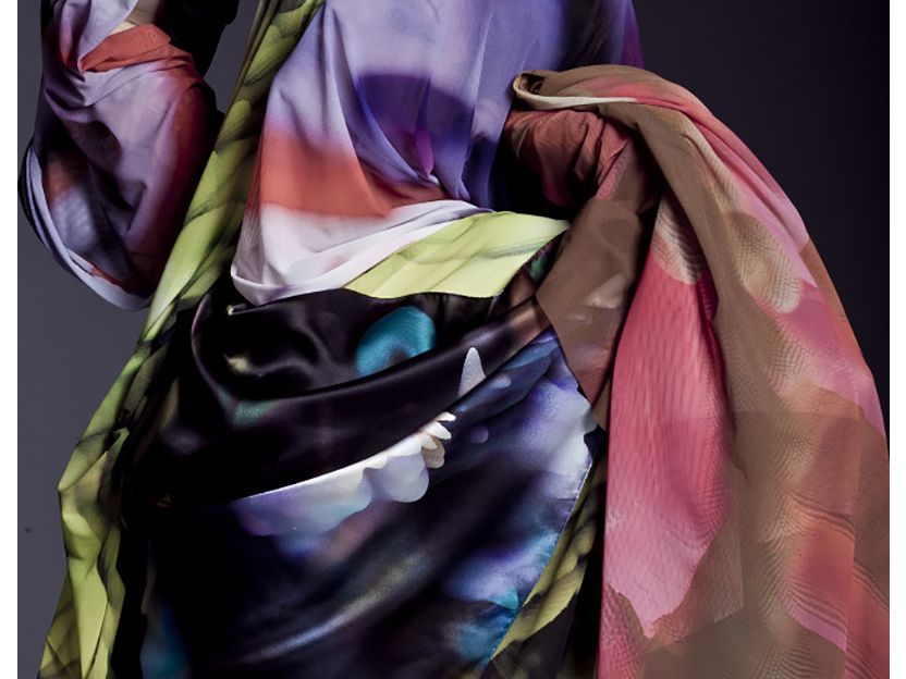 A figure is draped in scarves.
