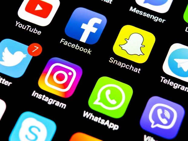 Social media app icons, including Facebook, Twitter and WhatsApp.