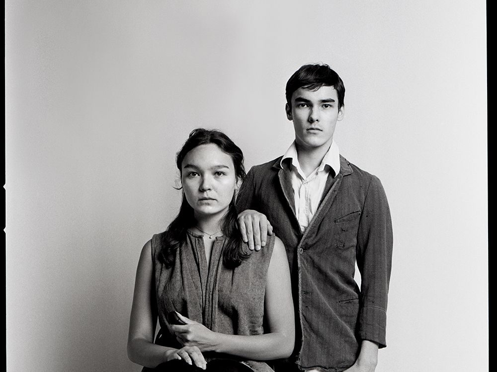 Two people sitting in a traditional portrait-style pose.