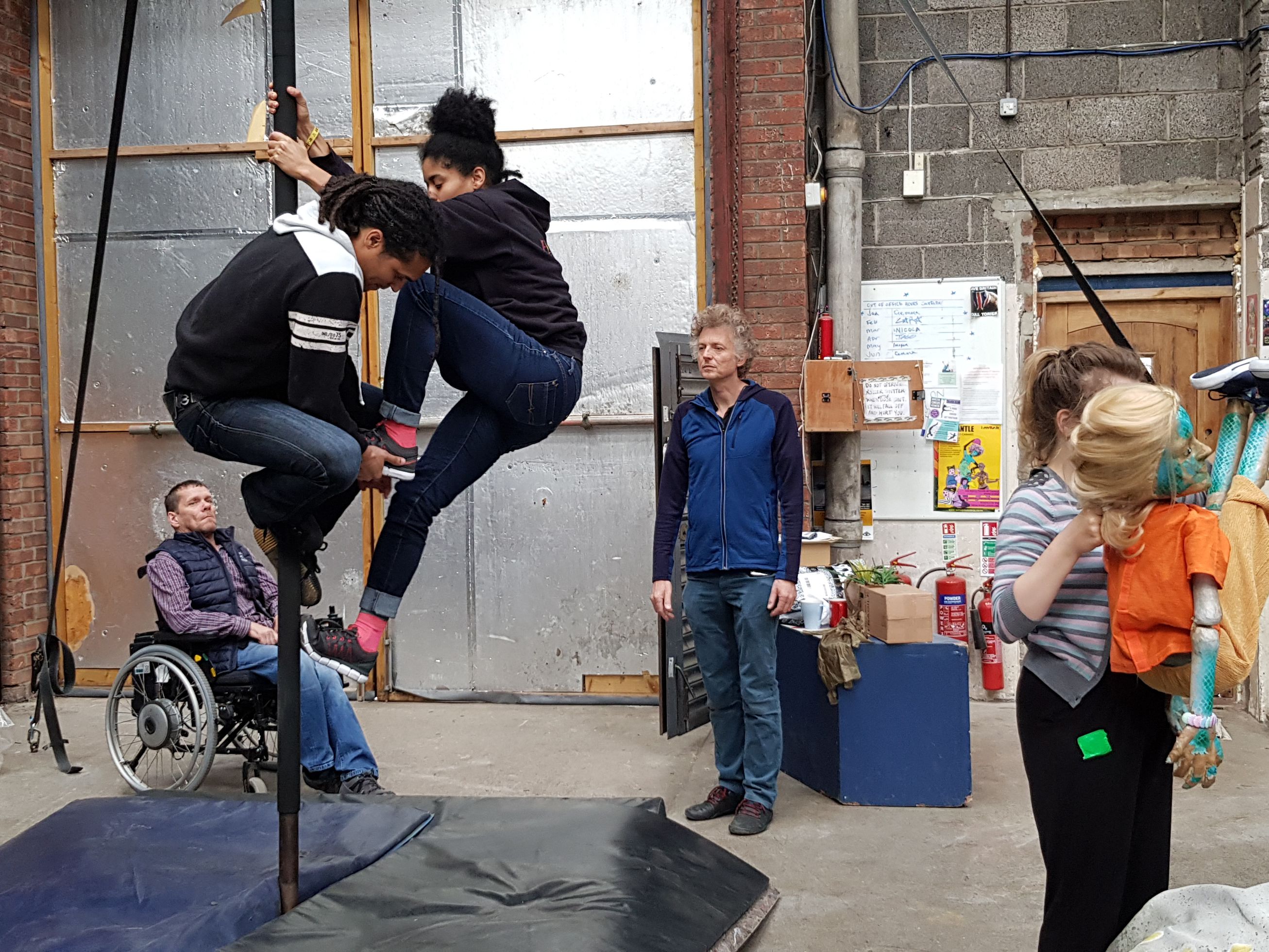 People in a studio practicing a performance