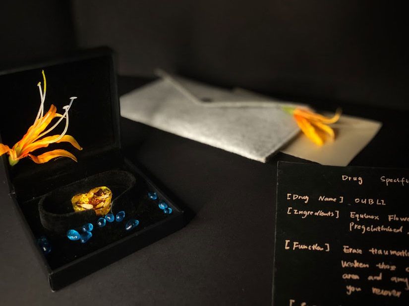 Image depicts a desk filled with papers and ornaments.